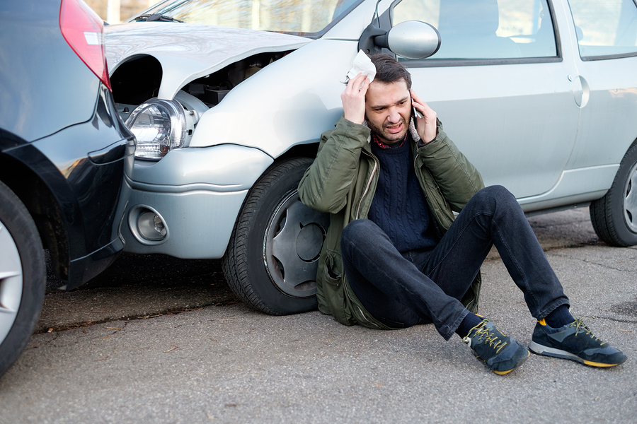 man with an injured head talking on the phone after a Georgia car accident