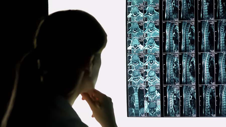 Neck and spine injury xrays being examined by a doctor