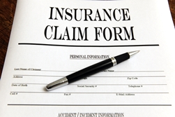 Insurance claim form with pen