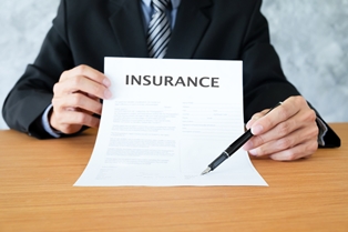 insurance adjuster holding a pen to sign forms