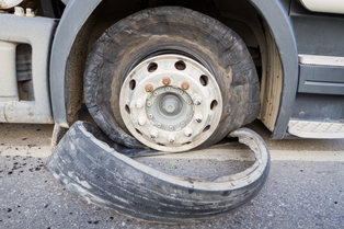 Semi-truck with a blown out tire
