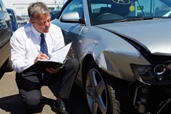 insurance adjuster inspecting vehicle
