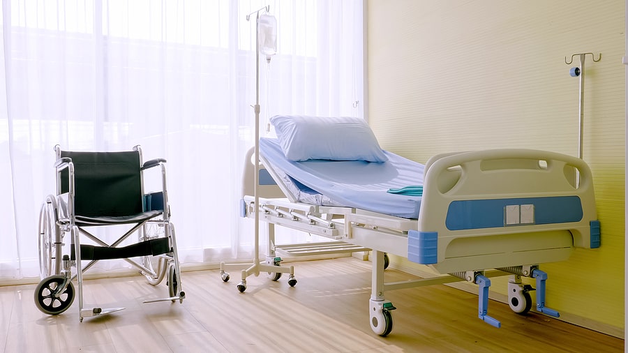 Empty hospital bed and wheelchair