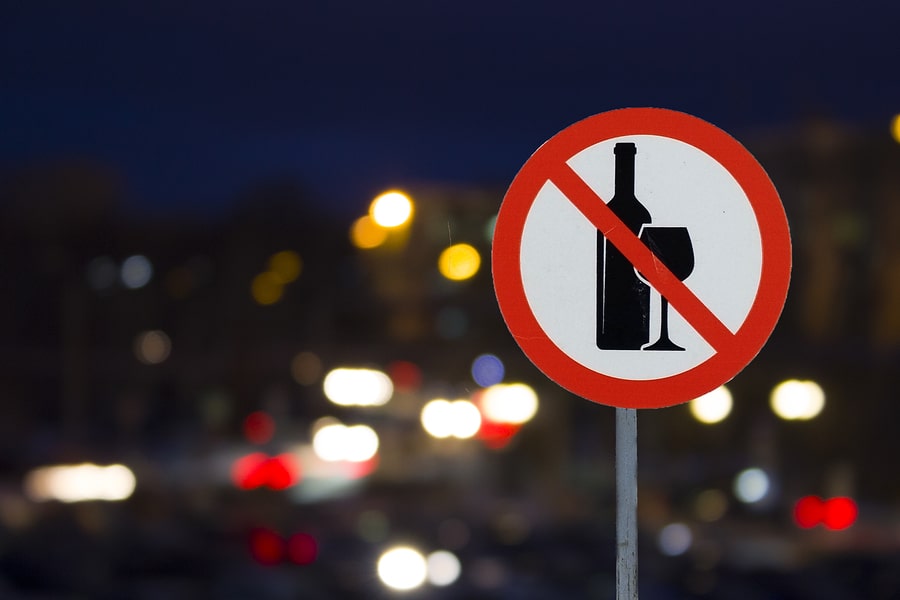 no drinking sign in front of a dark city