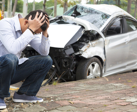 man with head in his hands after an accident