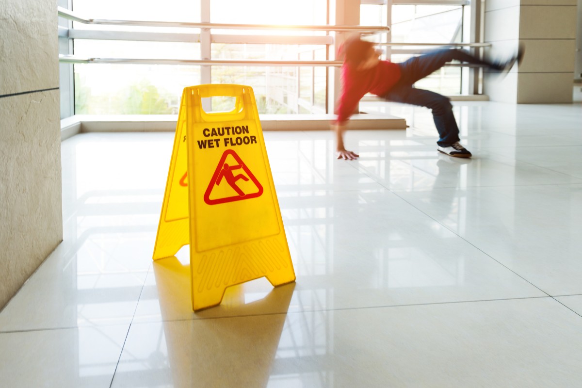 Person slipping on wet floor and falling