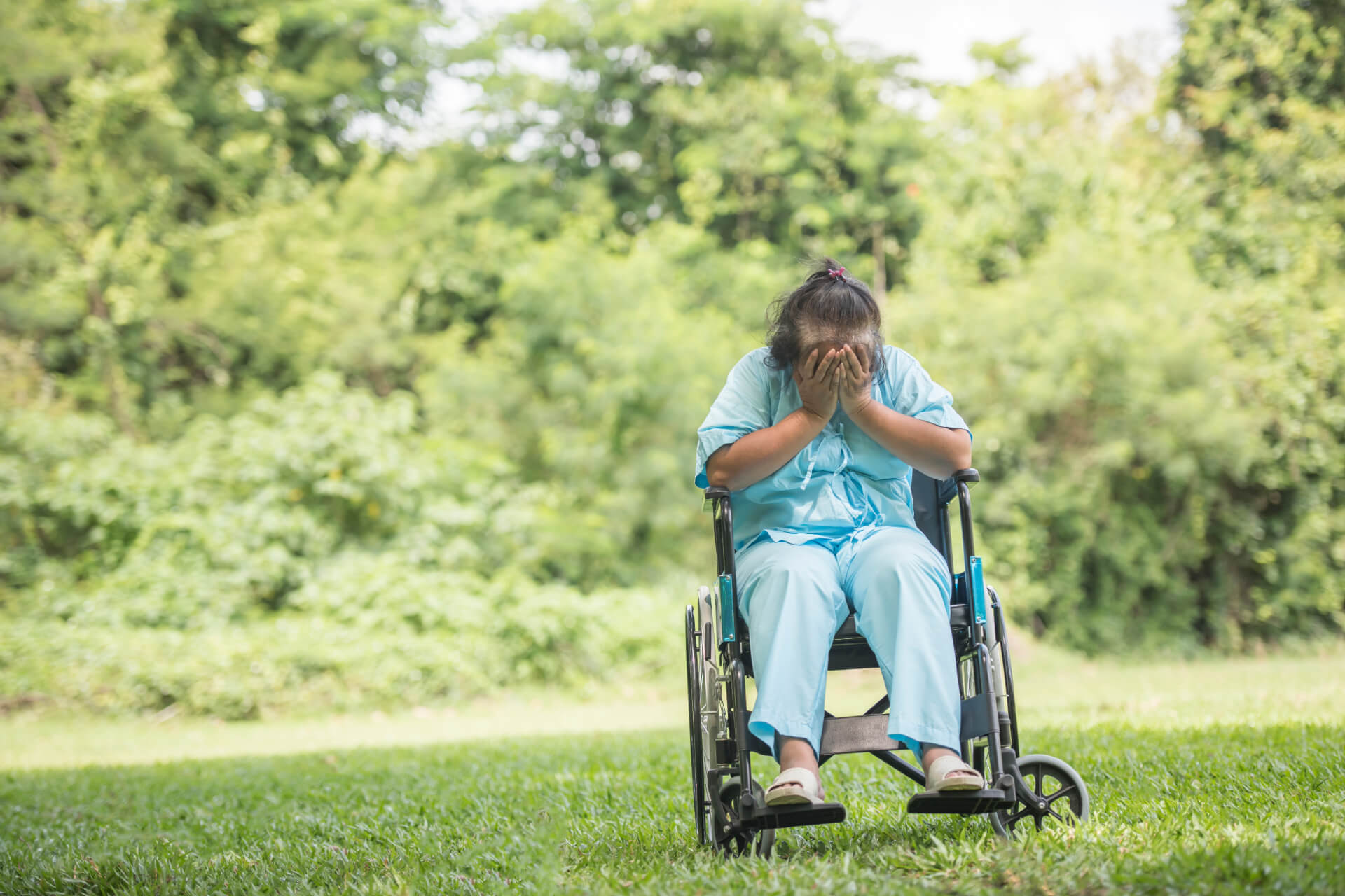 lonely elderly woman sitting on wheelchair feeling sad