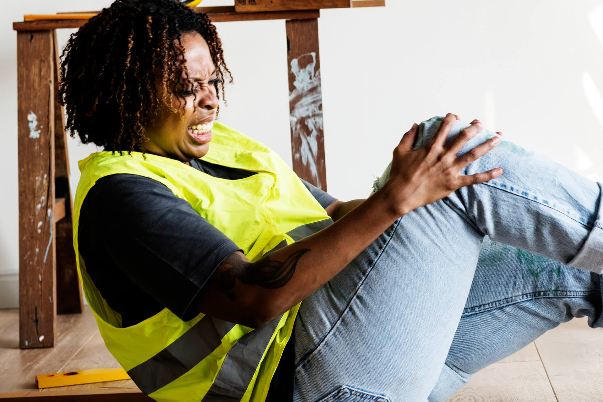 woman holding her knee after a construction accident