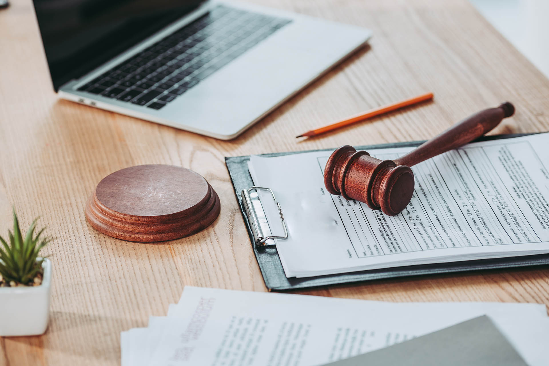 legal documents and gavel in front of laptop