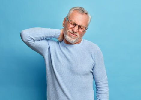 Aged man suffers from pain in the neck
