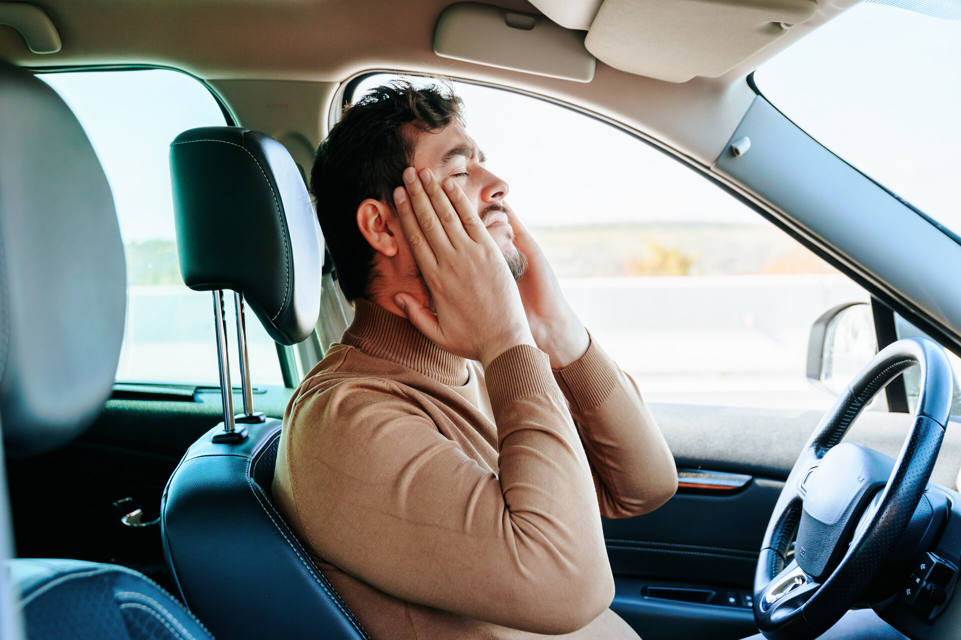 Driver in pain holding head