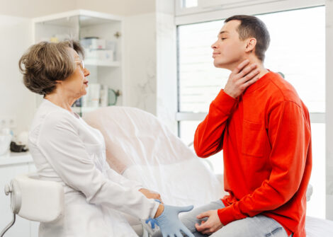 Patient describing neck pain to doctor