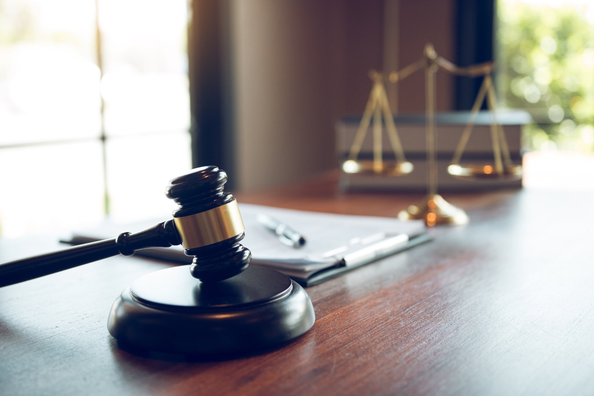 Close-up of a judge's gavel and legal documents in an office
