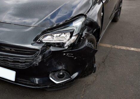 Front view of car with visible headlight and bumper damage