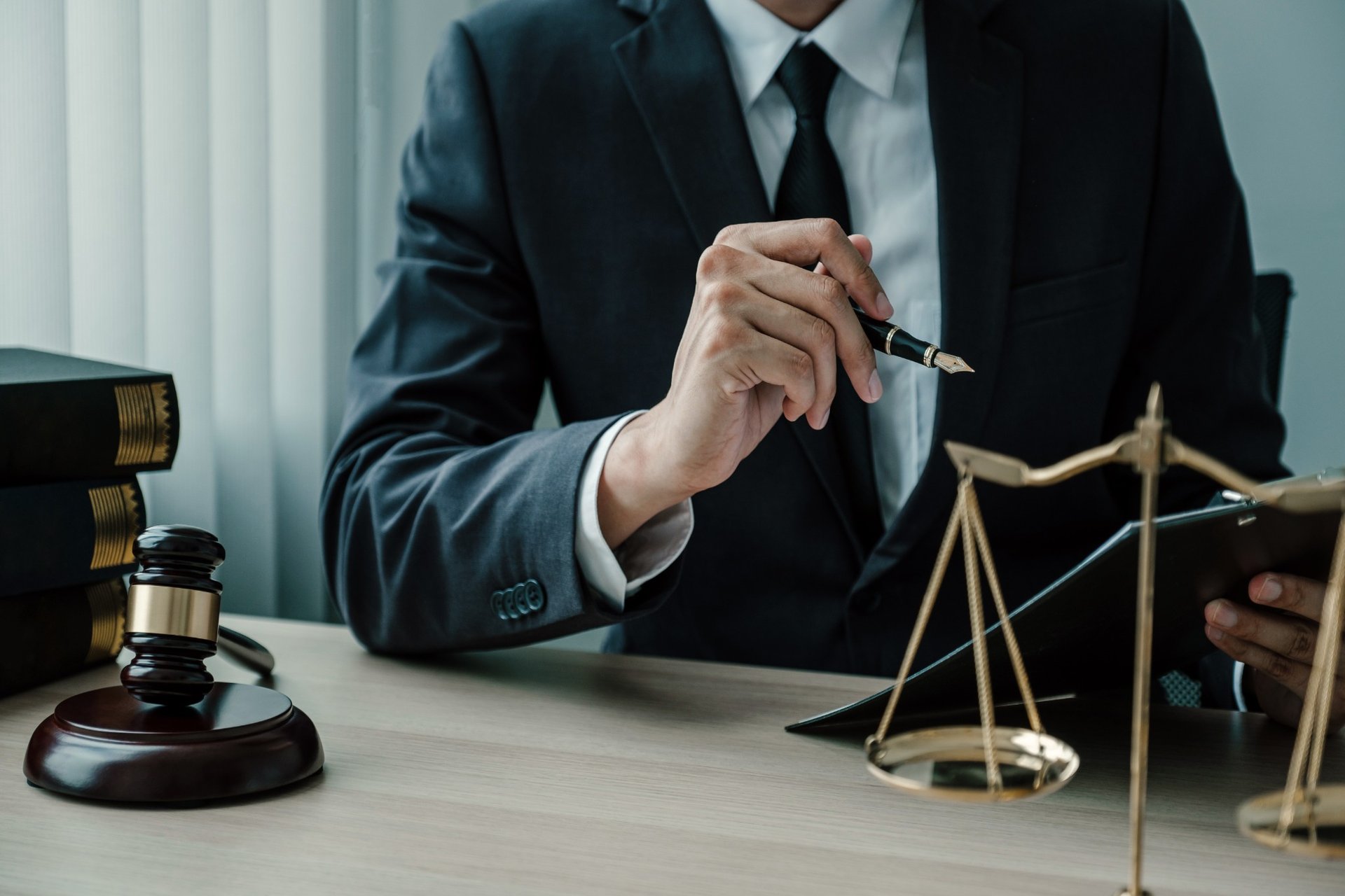 Lawyer consulting at desk with scale of justice and gavel