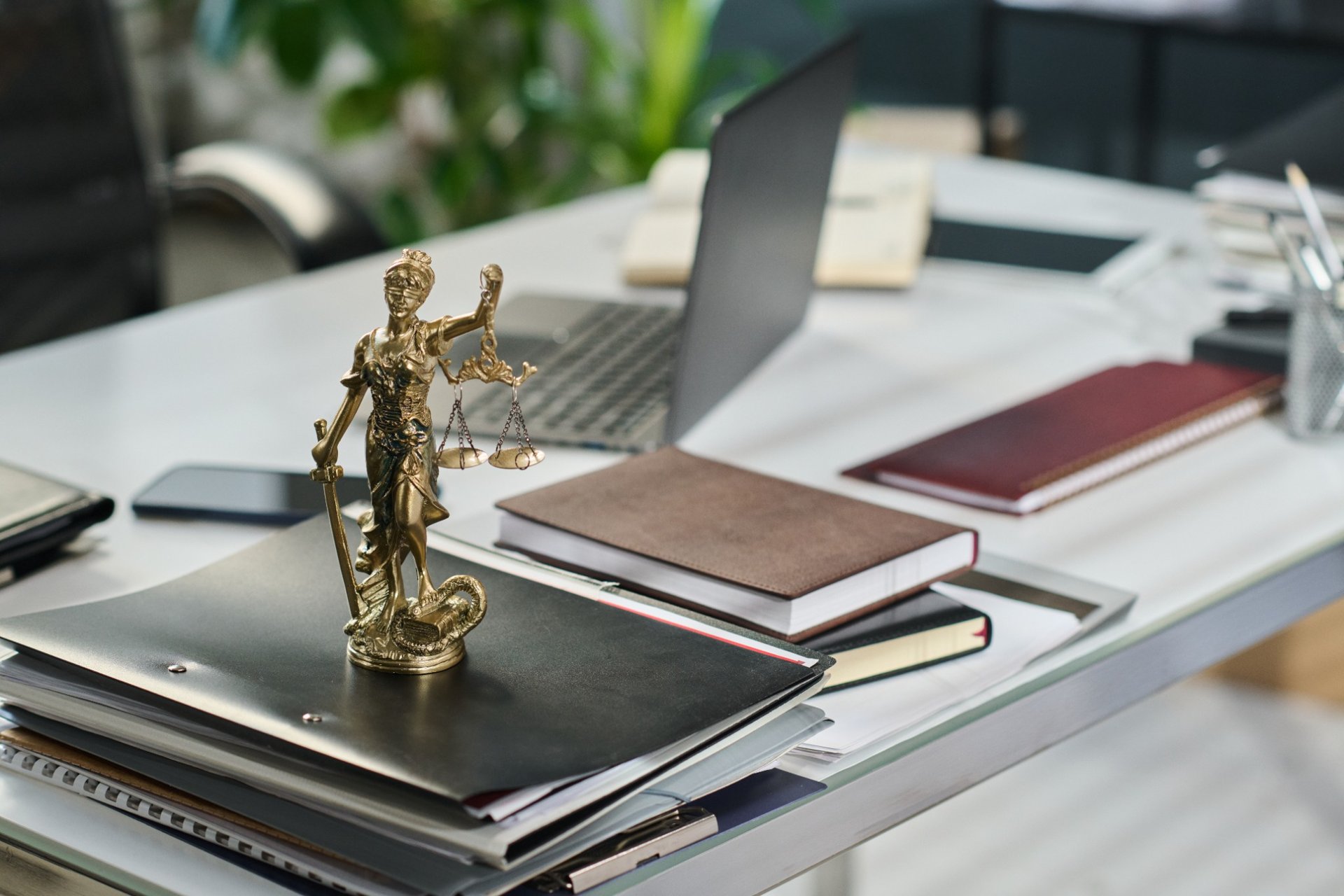 Statue of Lady Justice on a desk with legal documents