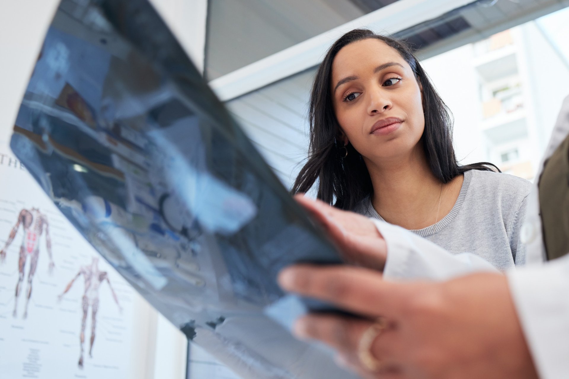 Woman examining an X-ray with her doctor in a clinic