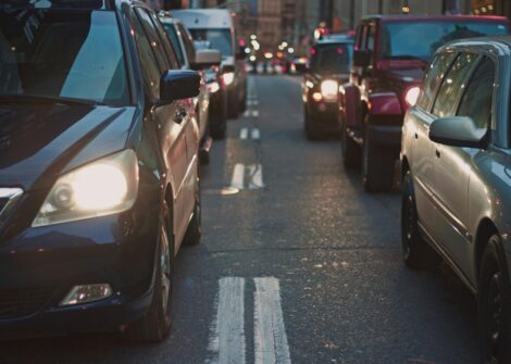 Congested urban street with cars and headlights during rush hour