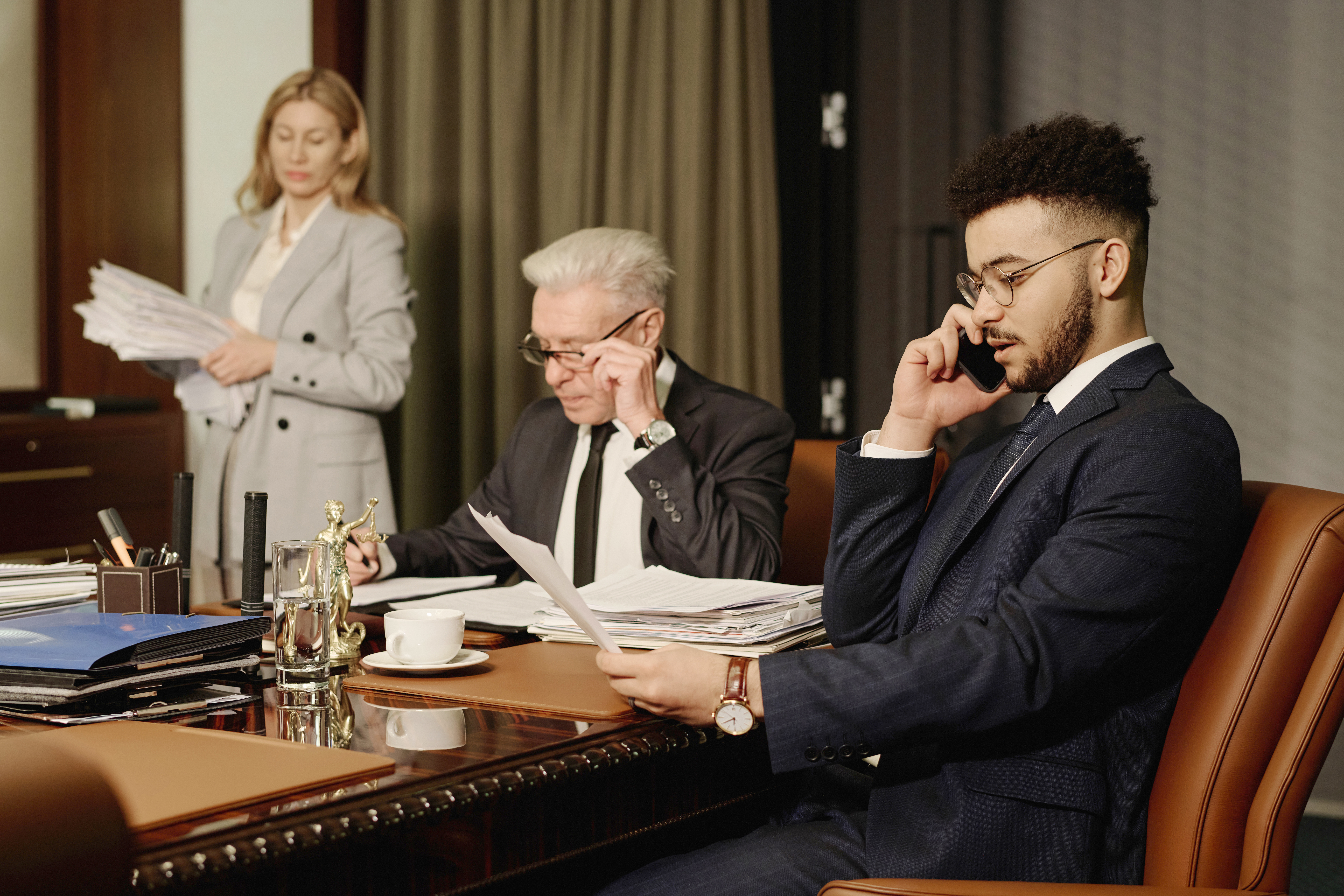 Biracial Group of Business People Working with Papers in Office