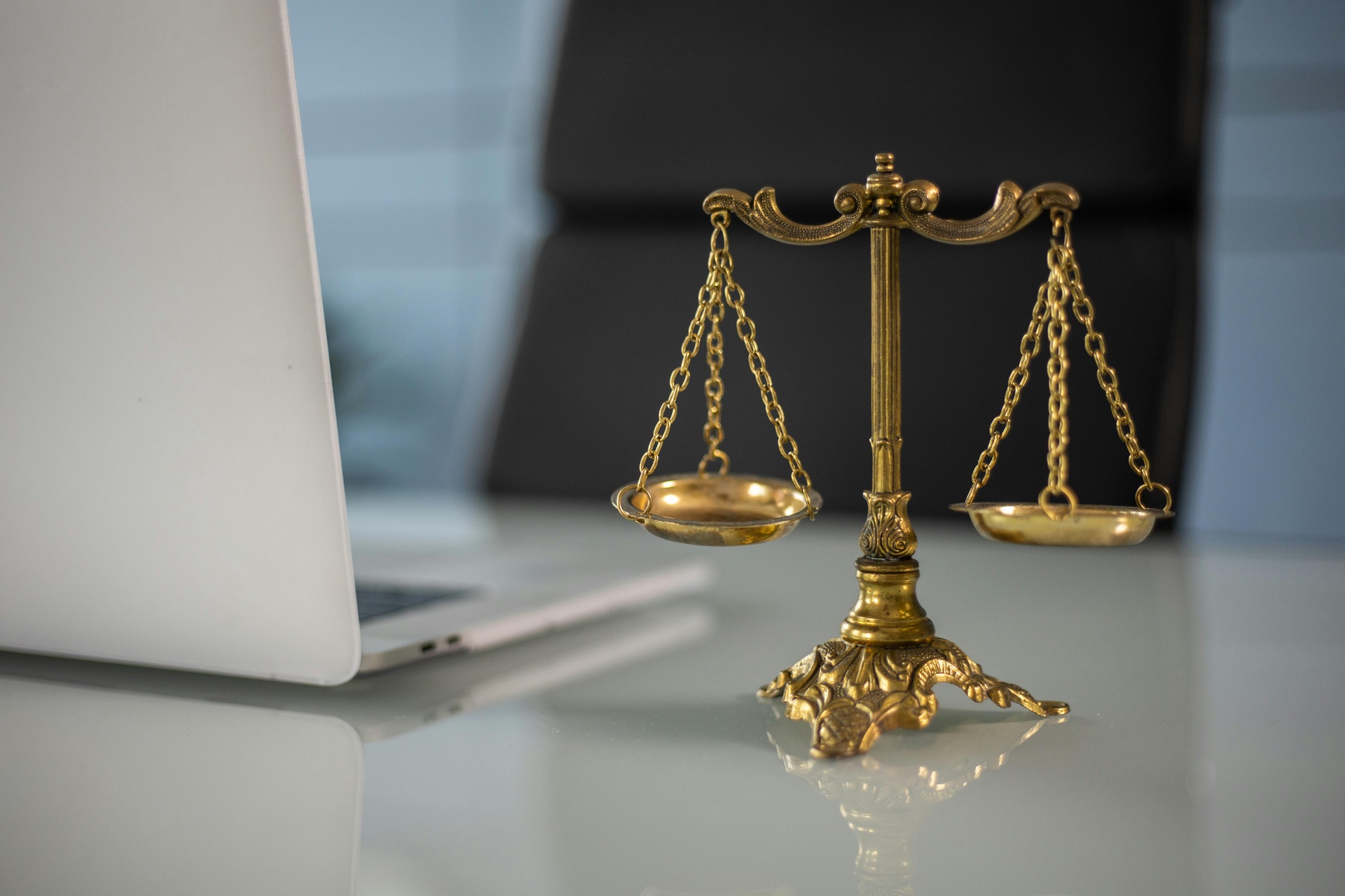 laptop and justice symbol on the desk